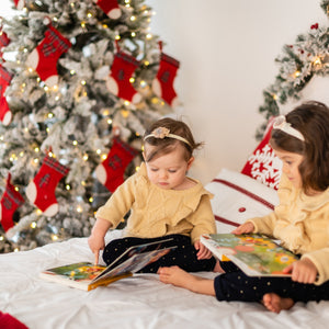 bebé e criança a ler e ouvir o livro musical com canções de Natal "linda noite"